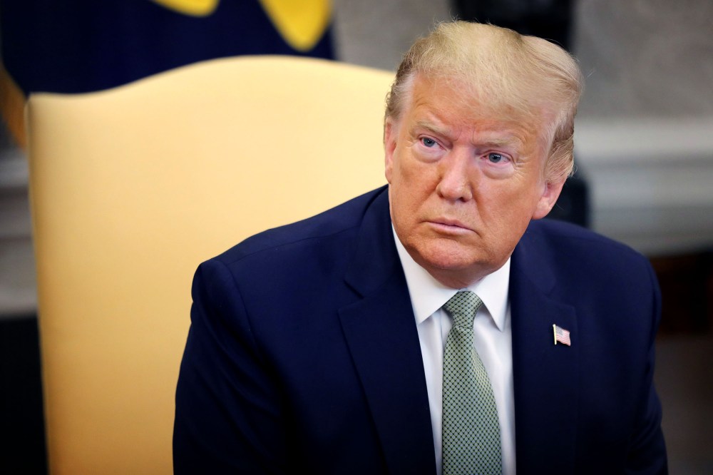 Image: President Donald Trump speaks to reporters in the Oval Office on March 12, 2020.