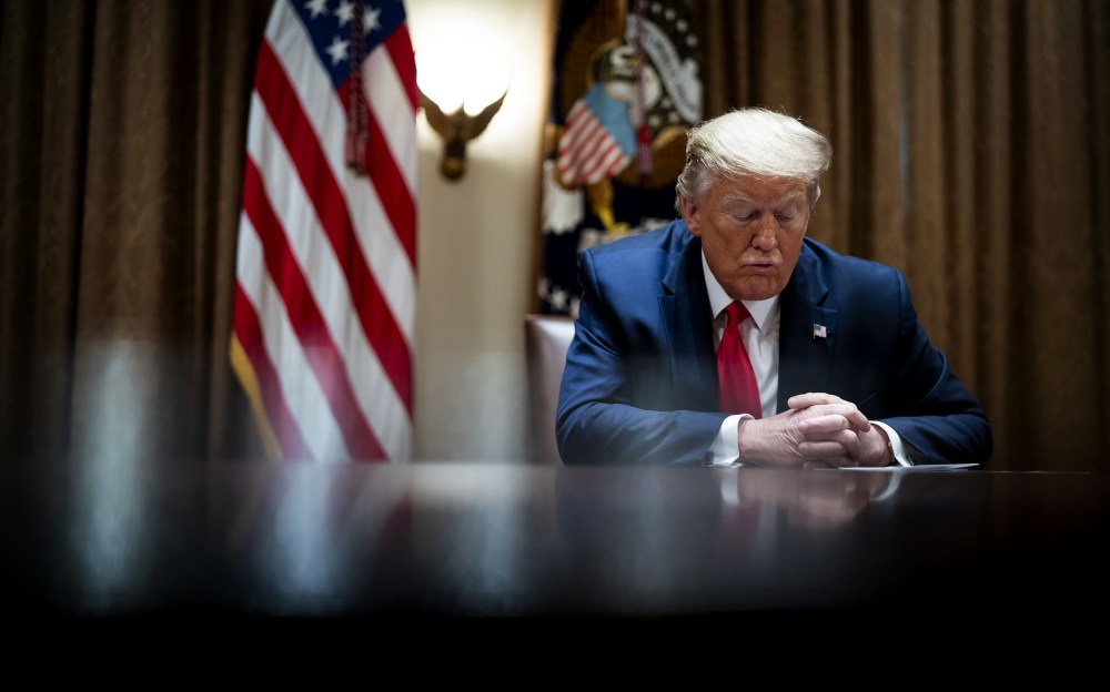 Image: President Donald Trump listens during a meeting in the Cabinet Room at the White House on April 14, 2020.