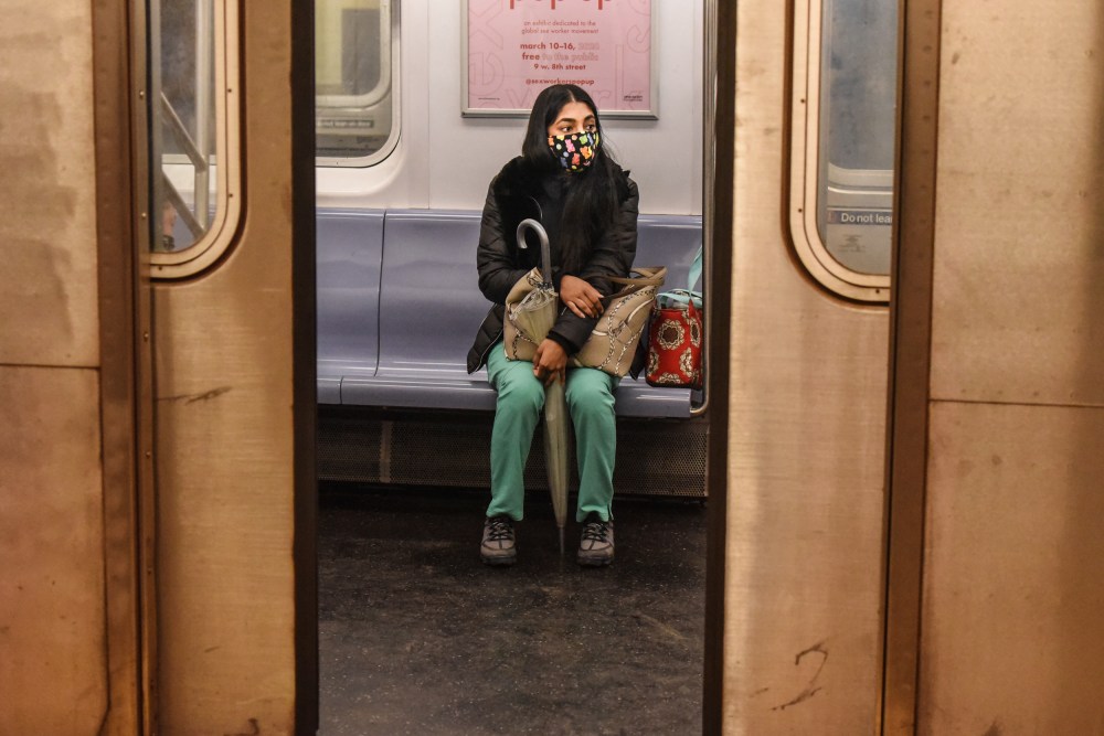 A passenger wears a mask while riding on a New York City subway train on May 6, 2020.