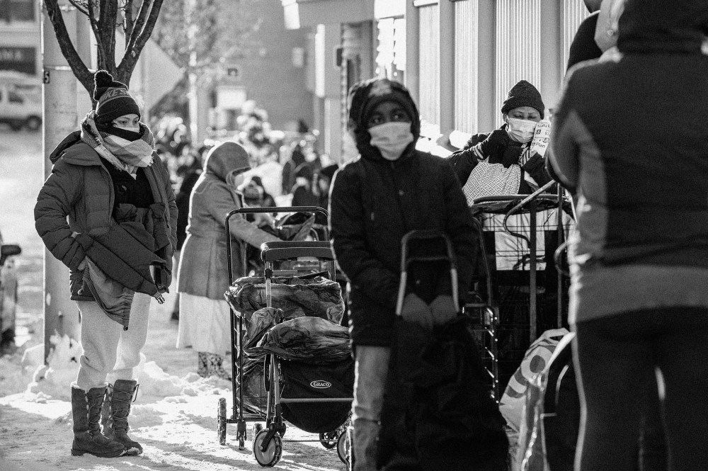 Image: People wait in line at a food pantry in Everett, Mass., on Dec. 19, 2020.