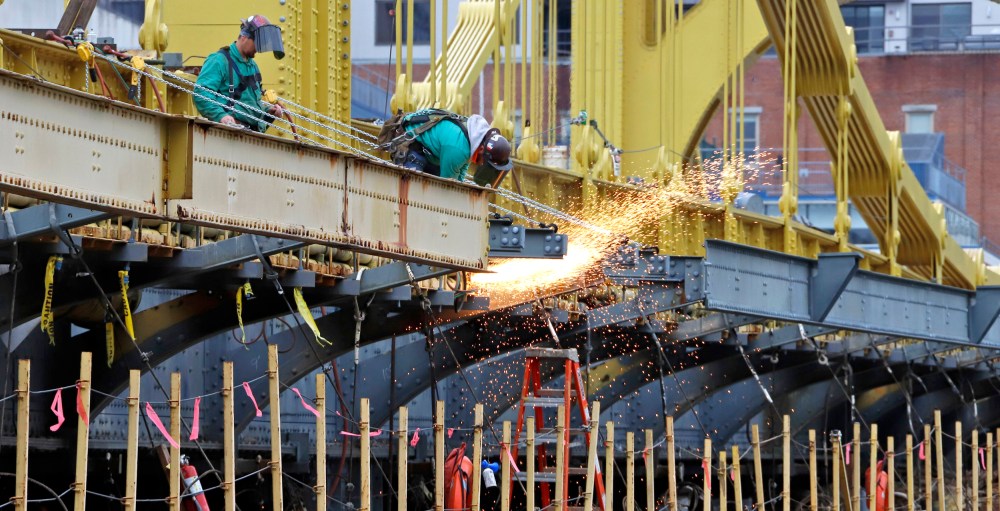 Image: worker welds on the Ninth Street bridge in Pittsburgh