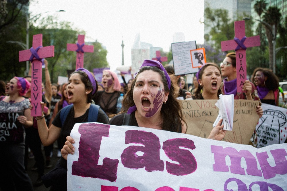 Image: Demonstrators with signs and crosses for the victims of femicide attend a national strike on International Women's Day in Mexico City on March 8, 2018.