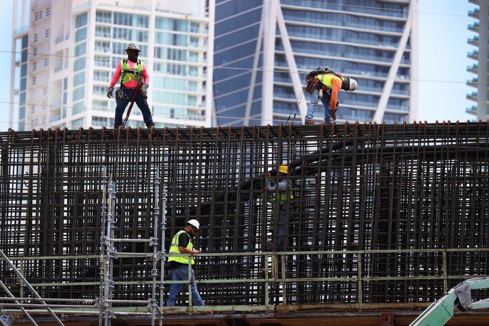 Construction workers build the "Signature Bridge" in Miami on March 17, 2021.