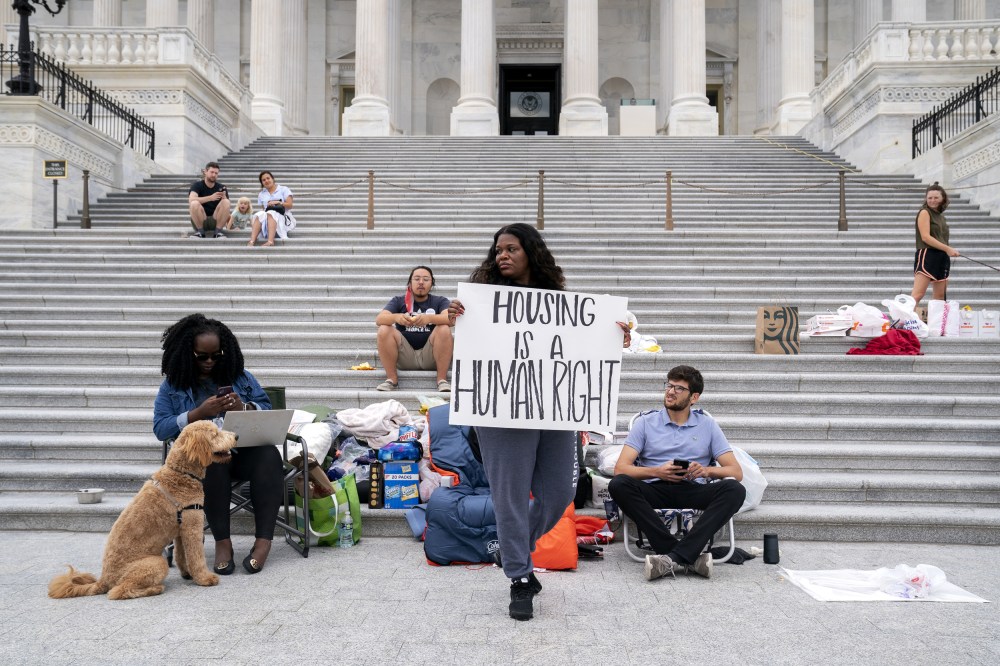 Rep. Cori Bush, D-Mo., center, joined by Congressional staffers and activists, protests the expiration of the eviction moratorium outside the Capitol on July 31, 2021.