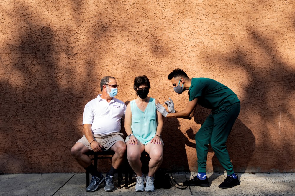 IMAGE: A woman receives a booster dose of the Pfizer-BioNTech Covid-19 vaccine at a pharmacy in Schwenksville, Pa., on Aug. 14, 2021.