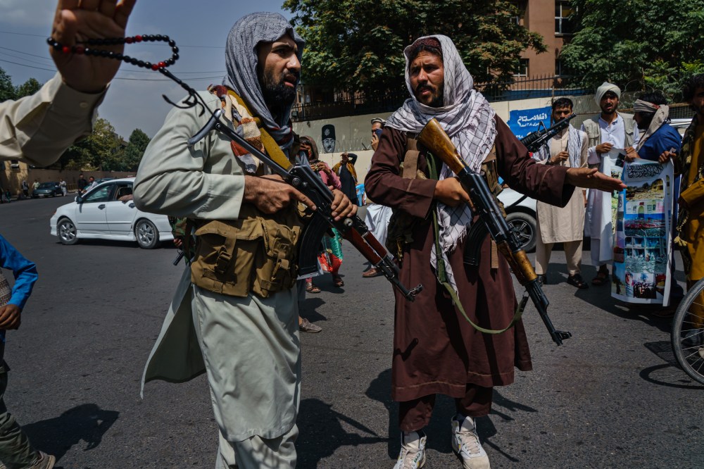 Image: Taliban fighters mobilize to control a crowd in Kabul, Afghanistan, on Aug. 19, 2021.