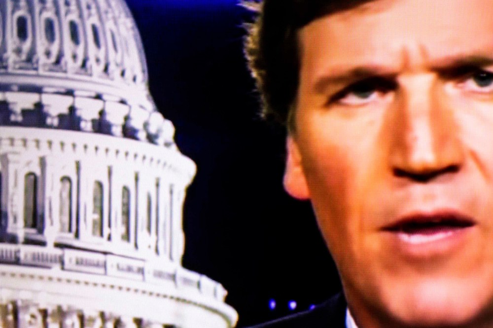 Image: Fox News anchor Tucker Carlson on a television screen in 2020.