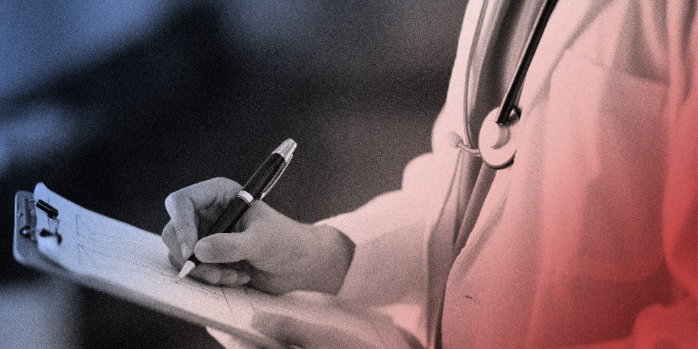 Image: A doctor writing a clipboard.