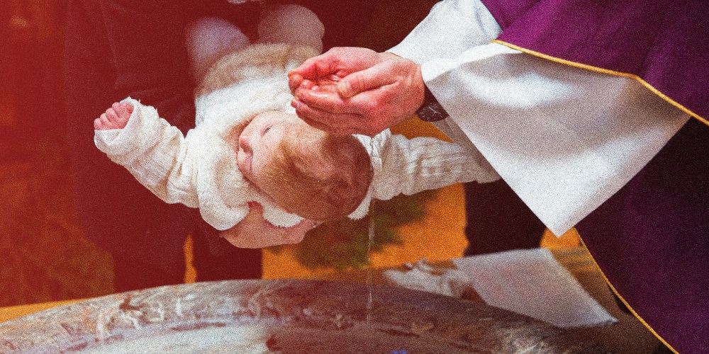 Image: Photograph of a priest is baptizing a baby in a church with a red color overcast.