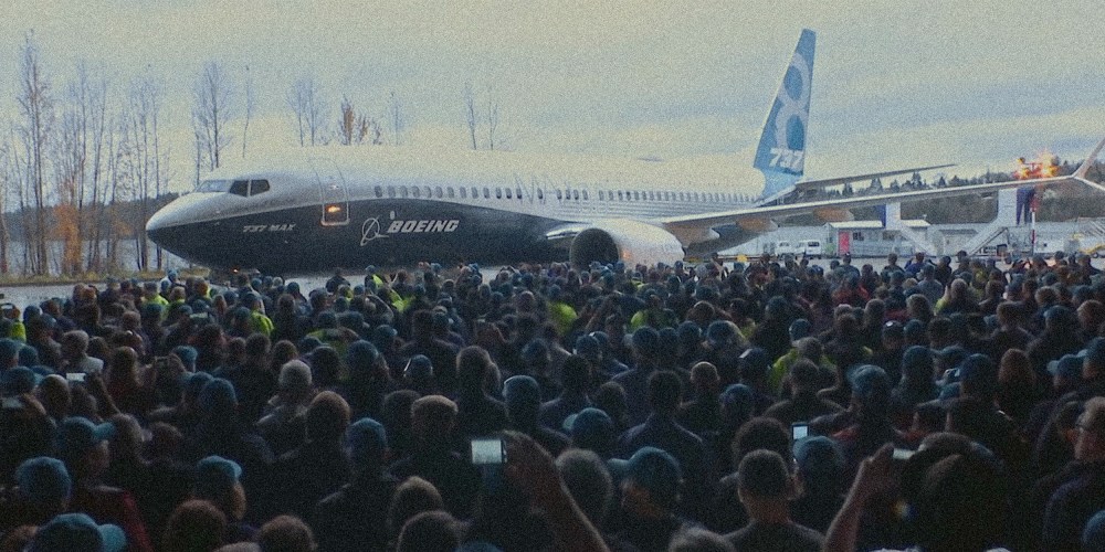 Image: Screengrab from the Netflix documentary,"Downfall: The Case Against Boeing.". A crowd of people around an airplane.