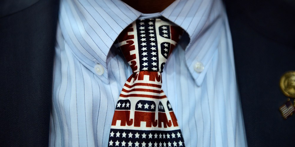 Image: A close-up of a tie decorated with with elephants, the Republican party mascots.