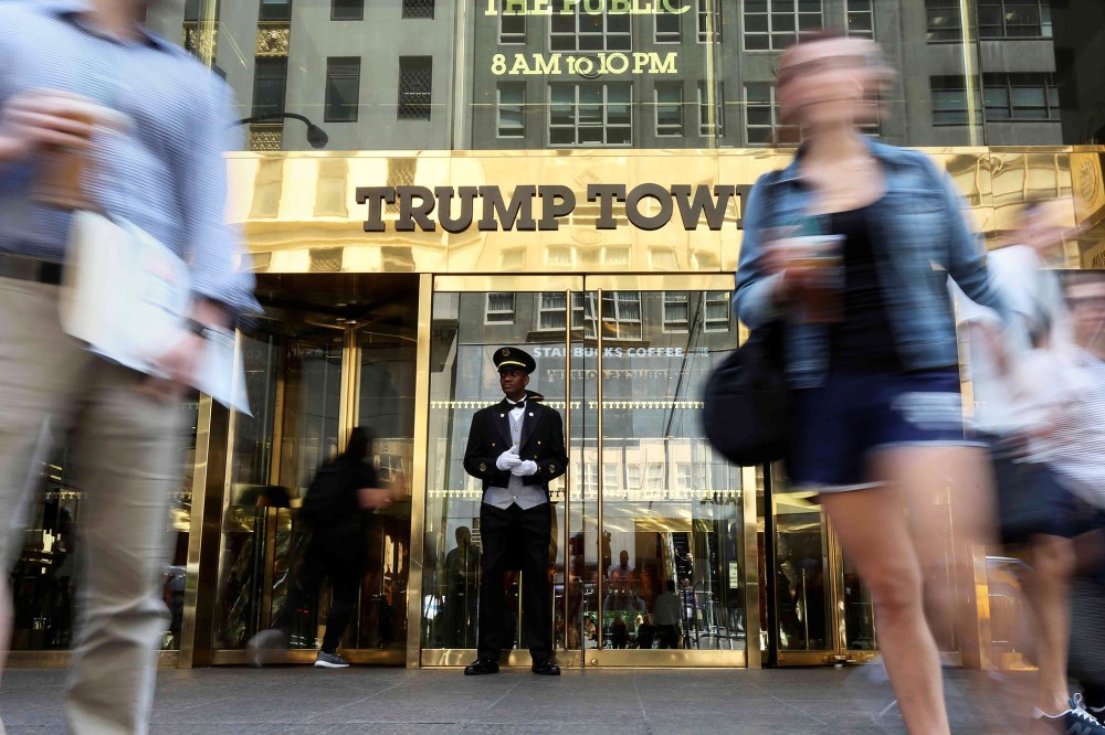 A doorman stands as people walk past the Trump Tower in N.Y. on May 23, 2016. (Photo by Carlo Allegri/Reuters)