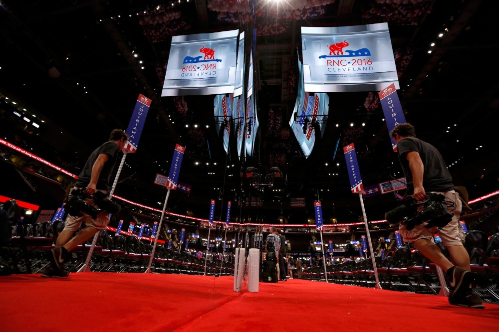 A cameraman's image is reflected as he sets up on the floor during the second day of the Republican National Convention in Cleveland, Ohio, July 19, 2016. (Photo by Mario Anzuoni/Reuters)