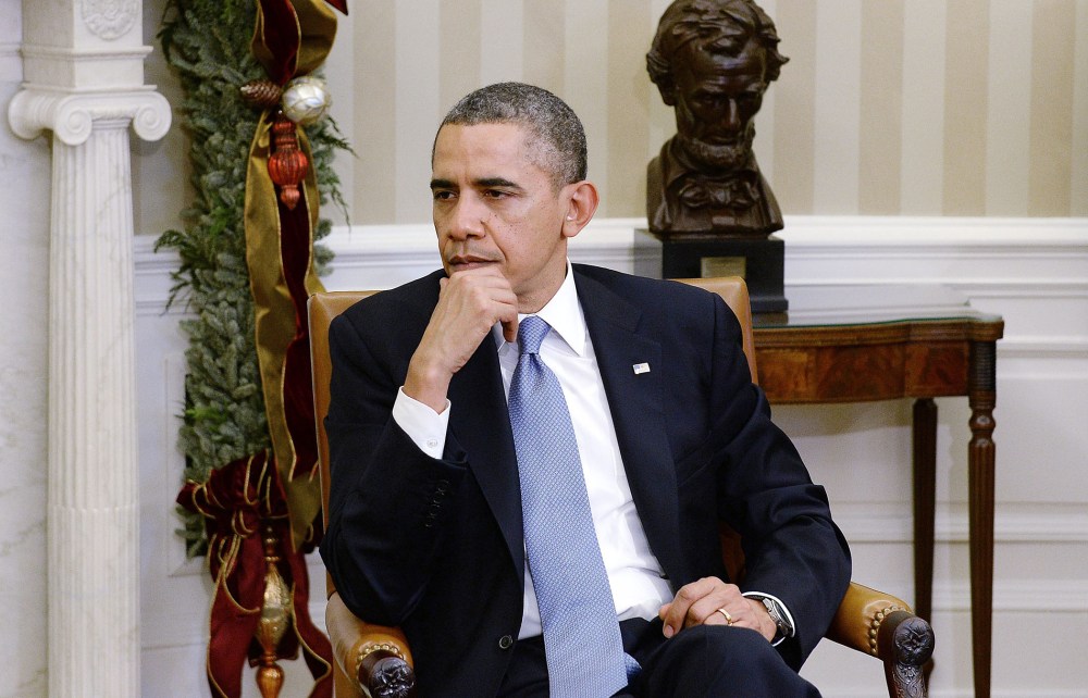 President Barack Obama meets with a group of mothers to discuss health care reform, in the Oval Office of the White House in Washington, D.C., December 18, 2013.