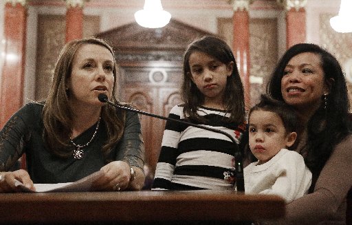 Theresa Volpe, left, testifies along side of her daughter Ava as her partner Mercedes Santos sits with their son Jaidon during a Senate Executive committee hearing considering same sex marriage at the Illinois State Capitol Thursday, Jan. 3, 2013 in...