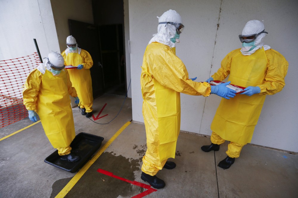 Students wearing personal protective equipment participate in a Centers for Disease Control and Prevention training session facility for healthcare workers treating Ebola virus victims in Anniston, Ala., on Oct. 15, 2014.