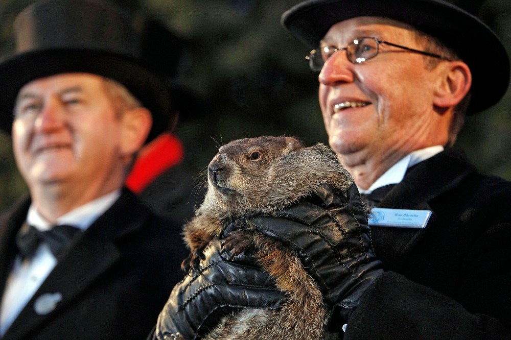 Groundhog Club handler Ron Ploucha (R) holds Punxsutawney Phil, the weather prognosticating groundhog, during the Groundhog Day celebration at Gobblers Knob in Punxsutawney, Pa., on Feb. 2, 2015. (Photo by David Maxwell/EPA)