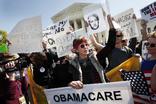 File Photo: Protesters who identified themselves as being with the Tea Party Patriots, including Linda Dorr, of Laguna Beach, Calif., center, demonstrate against the health care law outside of the Supreme Court in Washington, Monday, March 26, 2012. ...