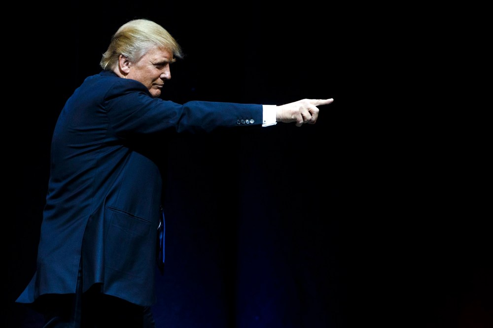Republican presidential candidate Donald Trump points at supporters after speaking at rally at the Verizon Wireless Center in Manchester, N.H., on Feb. 8, 2016. (Photo by Justin Lane/EPA)