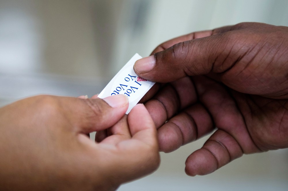 An 'I voted' sticker is handed out to a voter during the Maryland presidential primary election at Skyline Elementary School in Suitland, Md., April 26, 2016. (Photo by Shawn Thew/EPA)