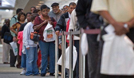 File Photo: People seeking employment line up outside a 2009 job fair in Baltimore, Maryland. Community programs, including job training courses, are under threat in the looming fiscal cliff. (Photo: Paul J. Richards/AFP/Getty Images)