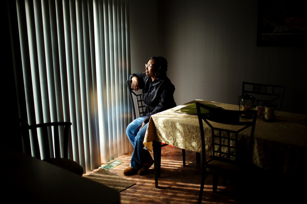 Renee Brooks looks out of the window in her home in District Heights, Maryland.