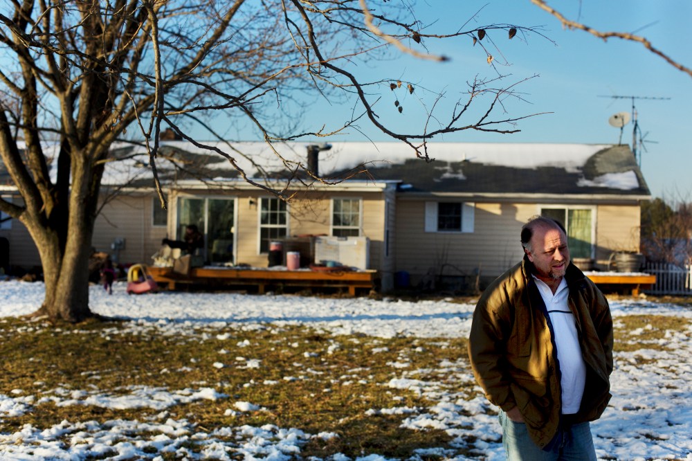 Paul Moody stands in the backyard of his home.