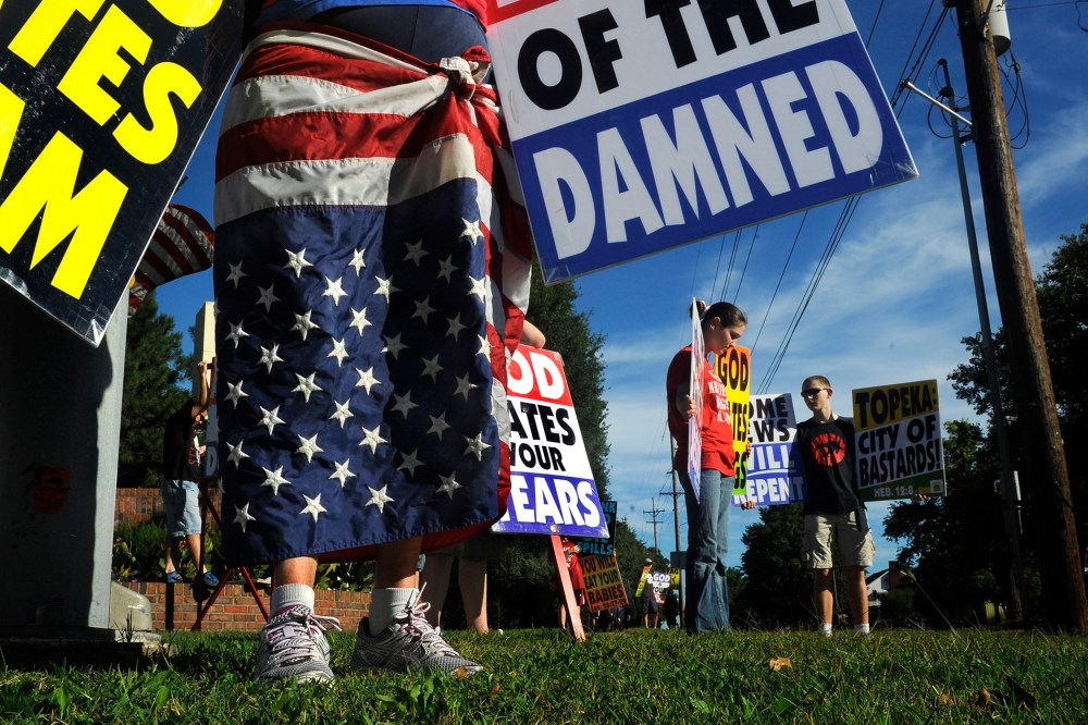 Members of the Westboro Baptist Church picket a city park near their church in Topeka, Kan.