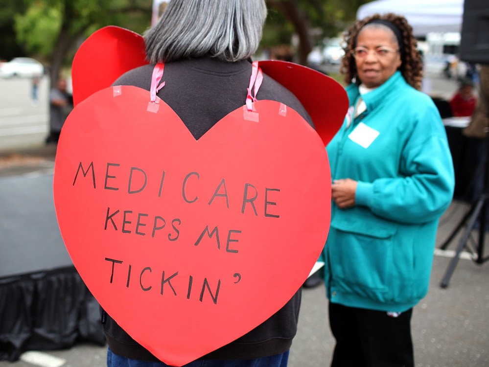 File Photo: A senior citizen holds a sign during a rally to protect federal health programs at the 8th Annual Healthy Living Festival on July 15, 2011 in Oakland, California.  (Photo by Justin Sullivan/Getty Images/FIle)