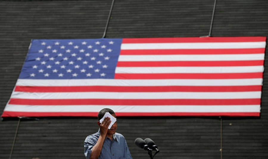 President Barack Obama wipes his brow while speaking at a campaign event at the Wolcott House Museum Complex July 5, 2012 in Maumee, Ohio.