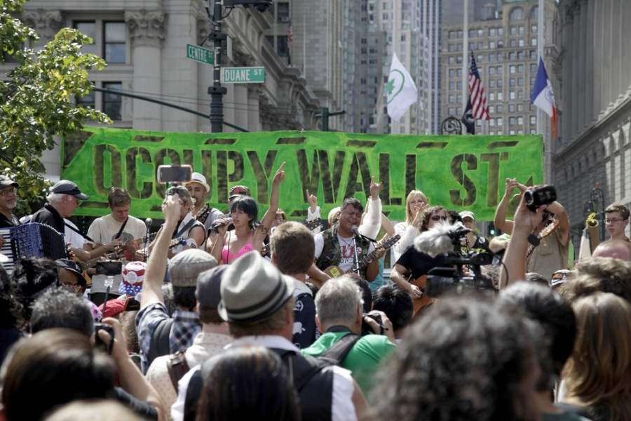People listen to an Occupy Wall Street anniversary concert in Foley Square in New York on Sunday, Sept. 16, 2012. The Occupy Wall Street movement will mark its first anniversary on Monday.