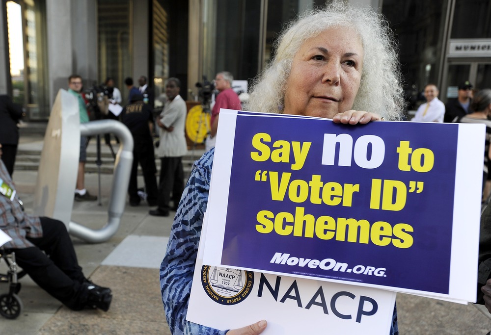 Gloria Gilman holds a sign during the NAACP voter ID rally to demonstrate the opposition of Pennsylvania's new voter identification law, Thursday, Sept. 13, 2012, in Philadelphia.