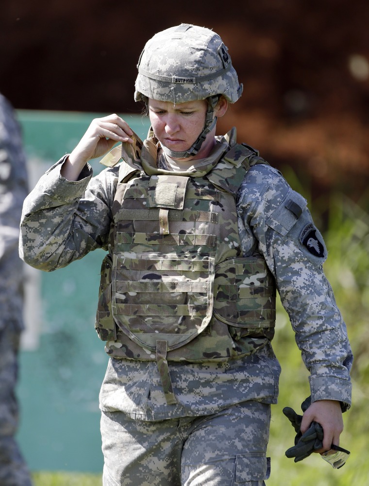 Spc. Sarah Sutphin adjusts her new body armor while training on a firing range on Tuesday, September 18, 2012, in Fort Campbell, Ky.