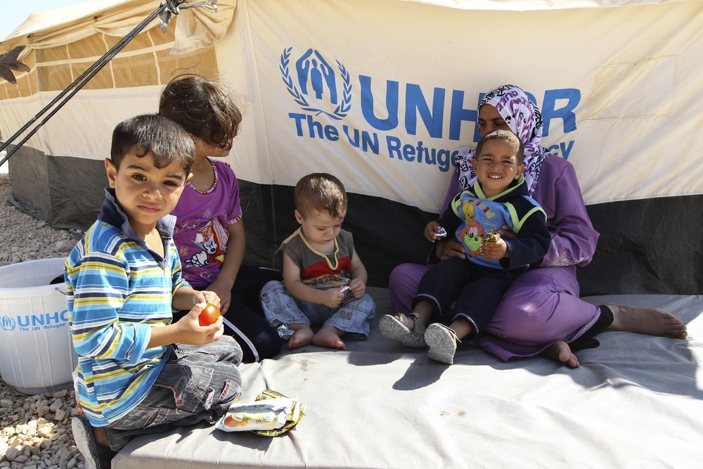 A Syrian refugee woman sits with her children during a visit by U.N. High Commissioner for Refugees (UNHCR) Antonio Guterres and Jordan's Foreign Minister Nasser Judeh to the Al Zaatri refugee camp in the Jordanian city of Mafraq September 11, 2012.