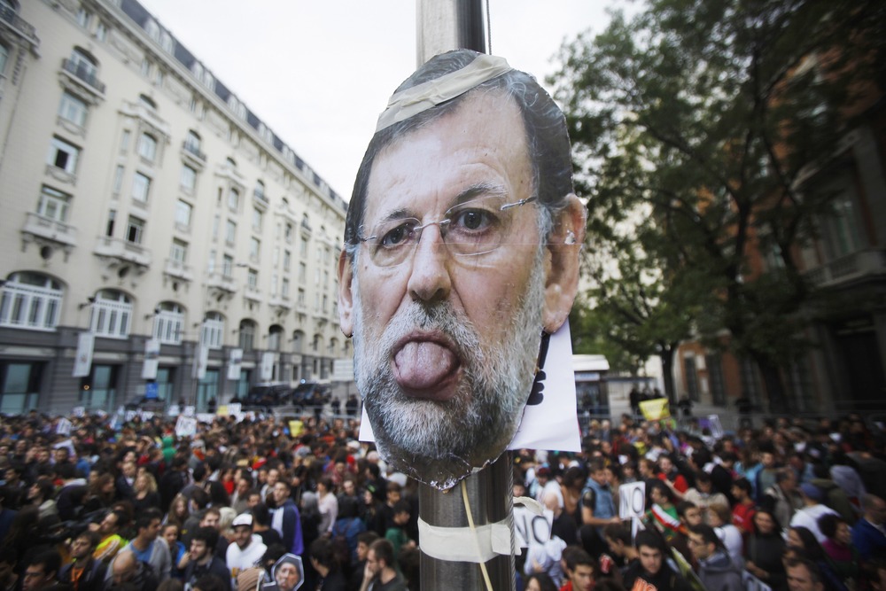 A picture of Spanish Prime Minister Mariano Rajoy is seen during the demonstration in Madrid.