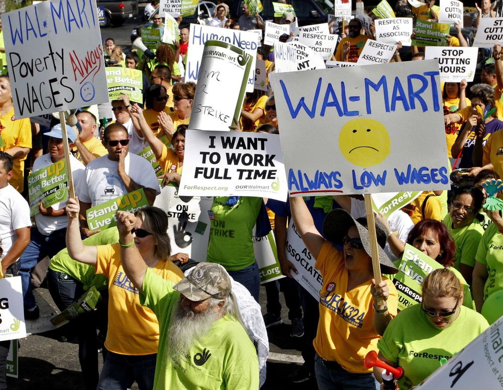 Striking Walmart workers gather during a rally to protest unsafe working conditions and poor wages outside a Walmart store in Pico Rivera, California, October 4, 2012. (REUTERS/Jonathan Alcorn)