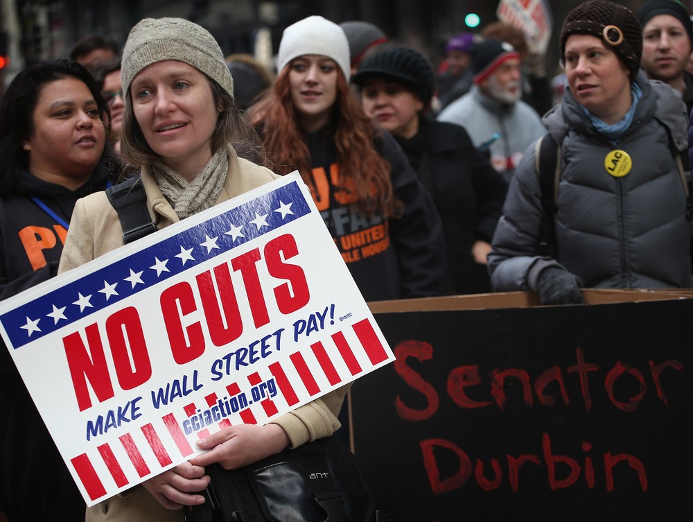 Protestors call for an increase of taxes on the wealthy and voice opposition to cuts in Social Security, Medicare, and Medicaid during a demonstration in the Federal Building Plaza on December 6, 2012 in Chicago, Illinois. (Photo by Scott Olson/Getty...