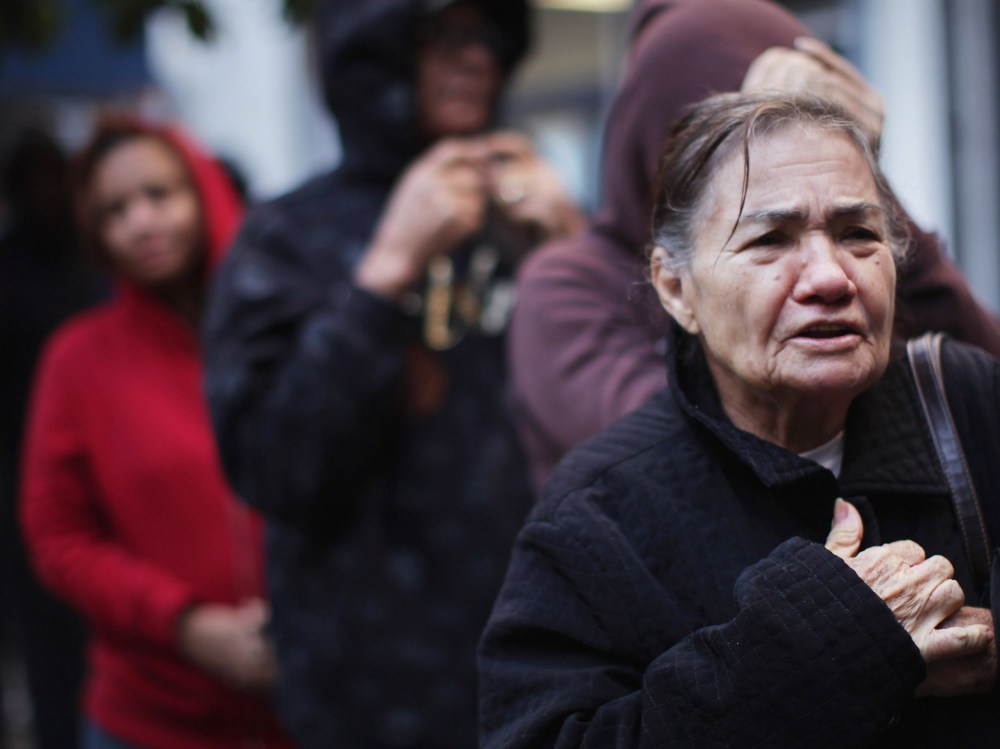 People wait in line to receive free milk from the Milk from the Heart program which makes weekly deliveries to Washington Heights and 12 other locations in Manhattan and the Bronx on October 6, 2011 in New York City.  As the economy throughout the...
