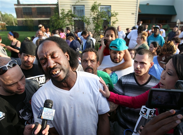Charles Ramsey talks to media as people congratulate him on helping some women get out of a home in the 2200 block of Seymour Ave on May 6, 2013. (Scott Shaw / The Plain Dealer)
