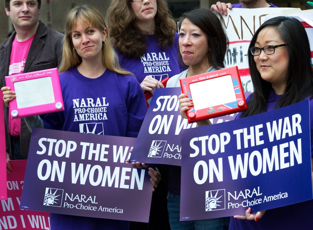 A member of the National Abortion Rights Action League (NARAL), Pro-Choice America protest with their "Etch A Sketch" in hand protest outside a hotel in Washington, DC, on March 22, 2012. (Photo by Paul J. Richards/AFP/Getty)