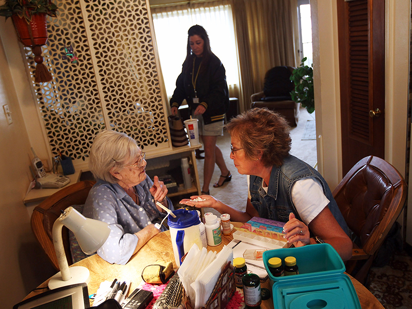 Home healthcare provider and registered nurse Susan Eager discusses medication with patient Helen Ricci, 96 during a house call on March 26, 2012 in Denver, Colorado. (Photo by John Moore/Getty)