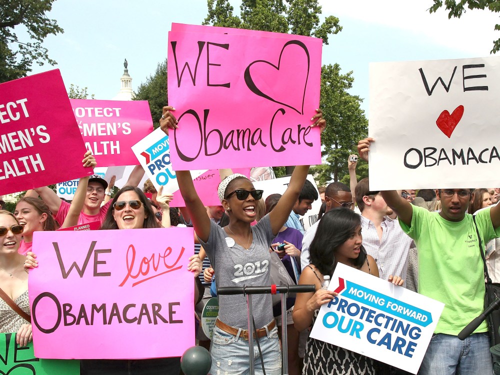 File Photo: Obamacare supporters react to the  U.S. Supreme Court decision to uphold President Obama's health care law, on June 28, 2012 in Washington, DC. Today the high court upheld the whole healthcare law of the Obama Administration.  (Photo by...