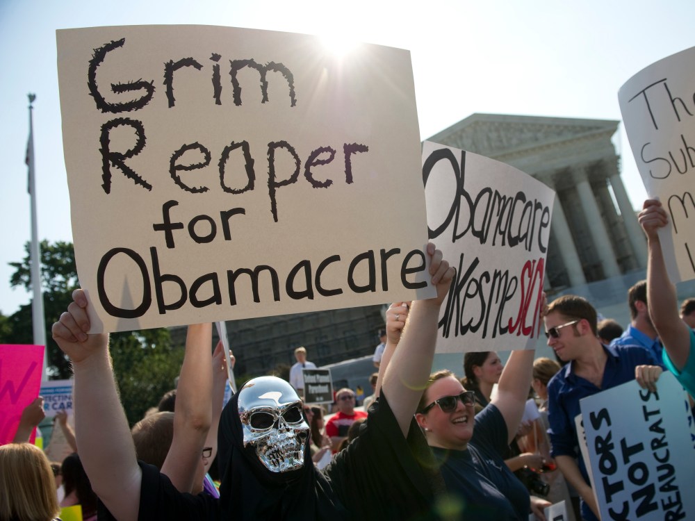 File Photo: Opponents of the Affordable Care Act rally before the Supreme announces its decision about the constitutionality of the president's efforts on health care reform. (Photo by Chris Maddaloni/CQ Roll Call, File)