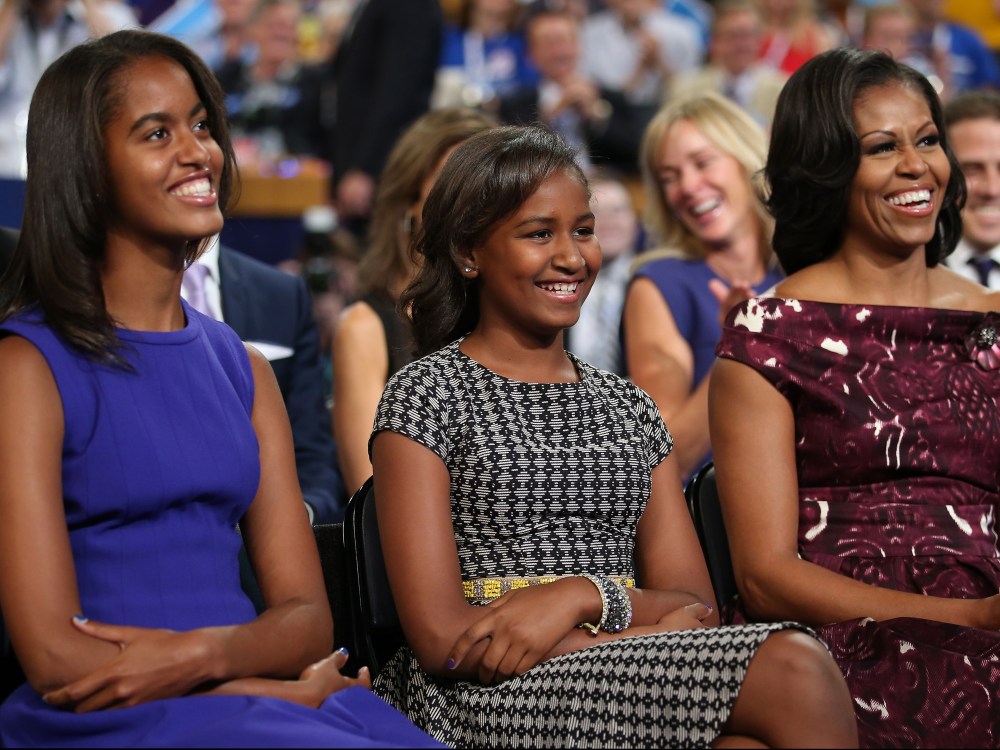 File photo: Malia Obama, Sasha Obama and first lady Michelle Obama listen as President Obama speaks at the DNC in Charlotte, North Carolina on September 6, 2012.  (Photo by Chip Somodevilla/Getty Images)