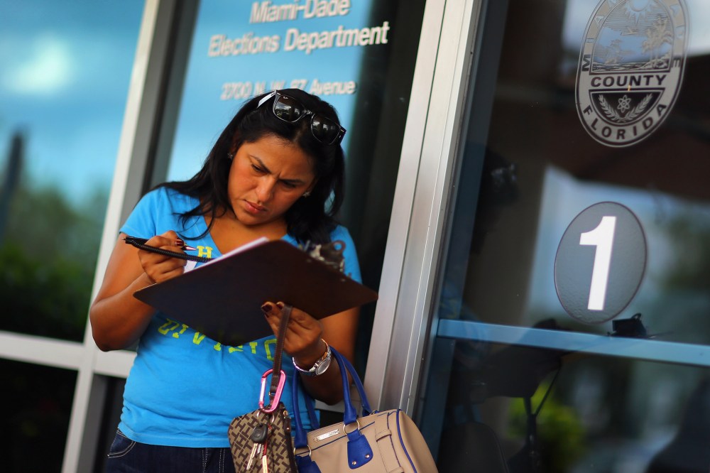Ereyda Monge fills out her voter registration form at the Miami-Dade Elections Department in Florida.