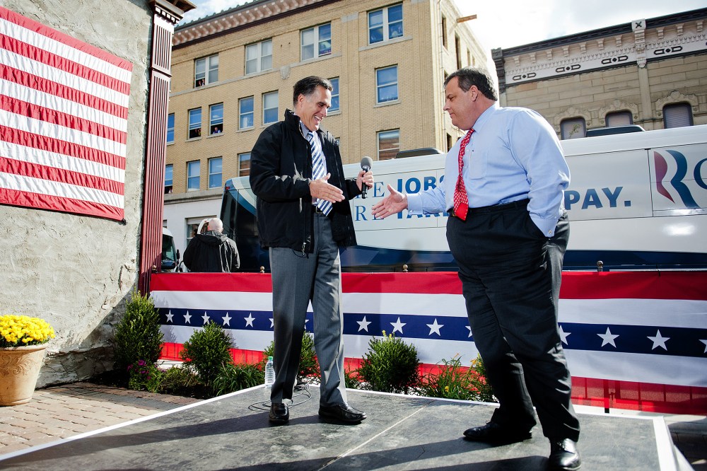 Mitt Romney shakes hands with Chris Christie as they talk with supporters at Buns Bakery and Restaurant in Delaware, Ohio, Oct. 10, 2012.