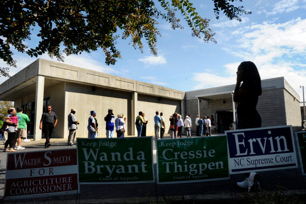 Campaign signs line the walk as people wait in line to vote in Wilson, North Carolina.