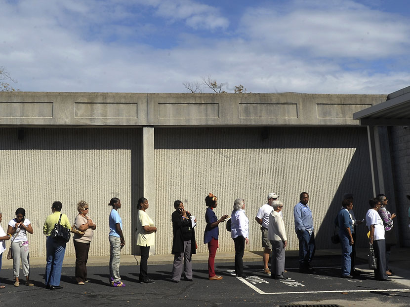 People wait in line to vote at the Board of Elections early voting site on October 18, 2012 in Wilson, North Carolina.