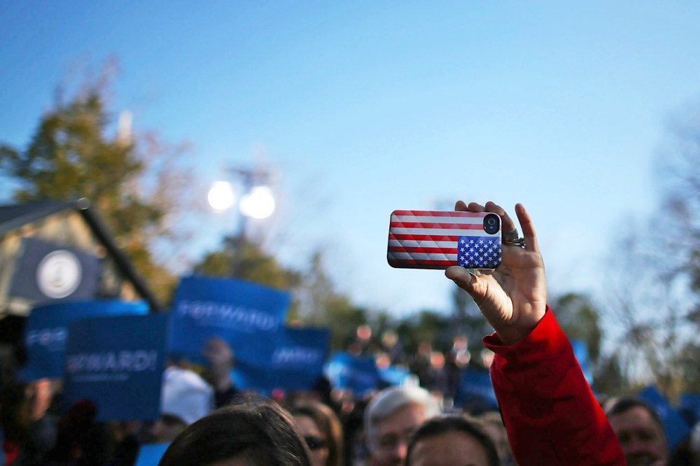 A cell phone with an American flag cover is held up during a rally  in Sterling, Virginia.