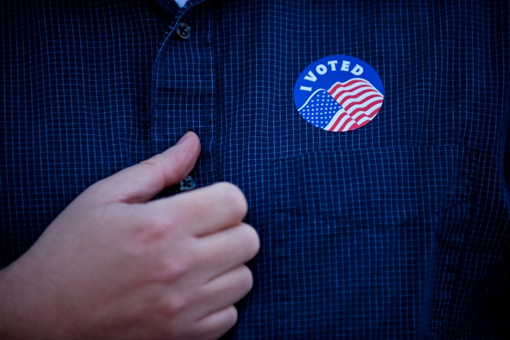 Rev. Chase Peeples displays his "I Voted" sticker after voting in Kansas City, Missouri, Nov. 6, 2012.